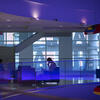 Business students studying together in a blue-lit lobby space