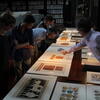 Tyler faculty examines prints with students. 