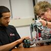Physics student and professor working together in a class